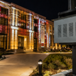 Climate controlled projector enclosure protecting a permanent outdoor projection mapping installation on a civic building.