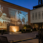 Climate controlled projector enclosure supporting museum projection mapping in an outdoor exhibit courtyard.
