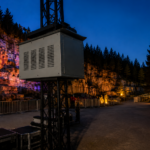 Climate controlled projector enclosure supporting projection mapping for a theme park attraction.
