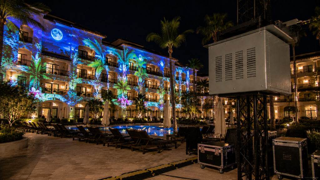 Climate controlled projector enclosure supporting resort projection mapping in an outdoor hospitality courtyard.