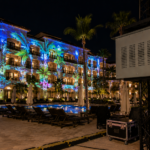 Climate controlled projector enclosure supporting resort projection mapping in an outdoor hospitality courtyard.