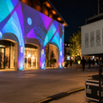 Climate controlled projector enclosure supporting retail storefront projection mapping for an outdoor brand display.