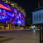 Climate controlled projector enclosure supporting stadium projection mapping for a large outdoor sports venue.
